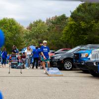Attendee plays ladder ball game during Family Day tailgate.